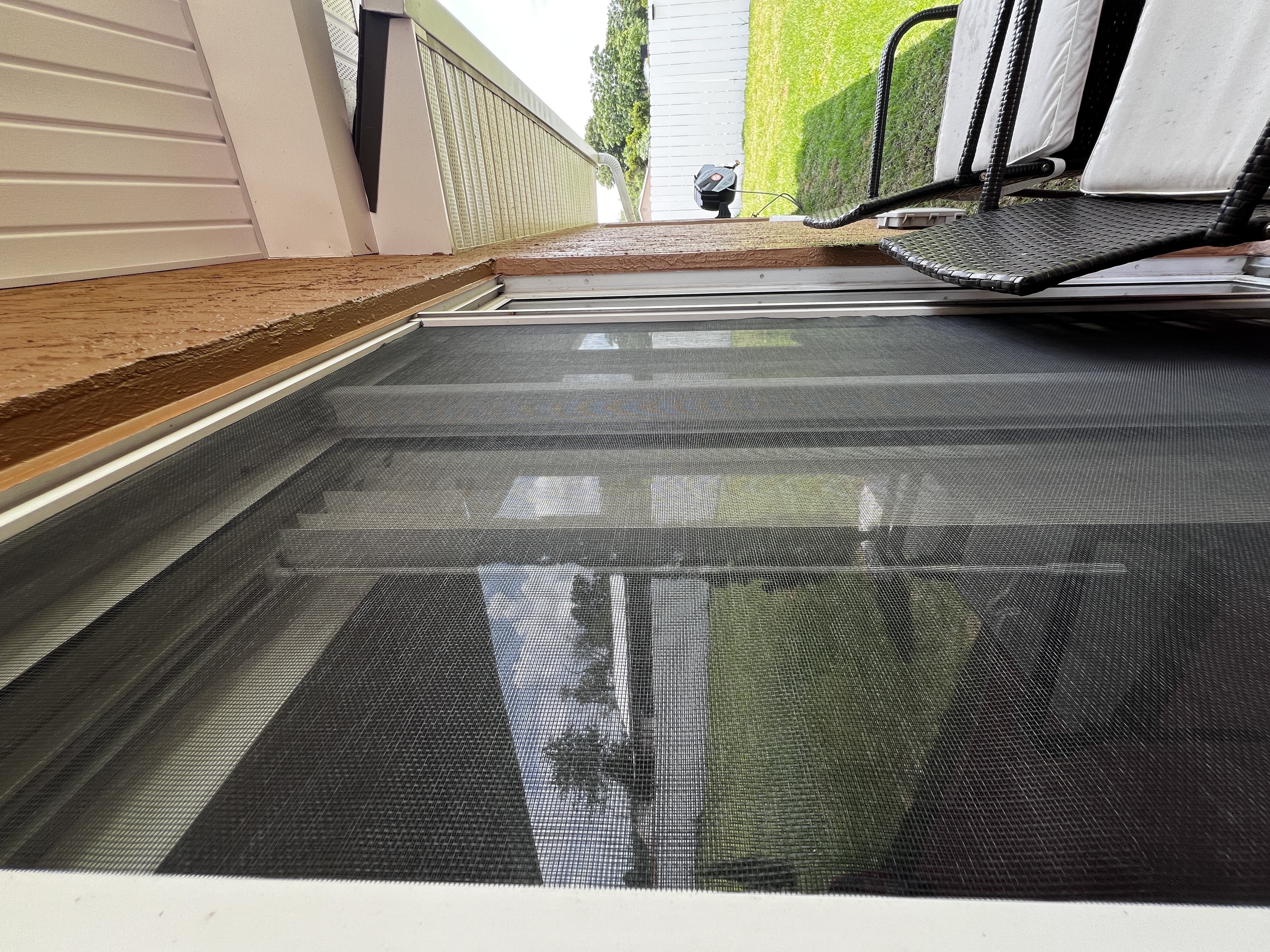 New screen mesh installed on a patio screen door